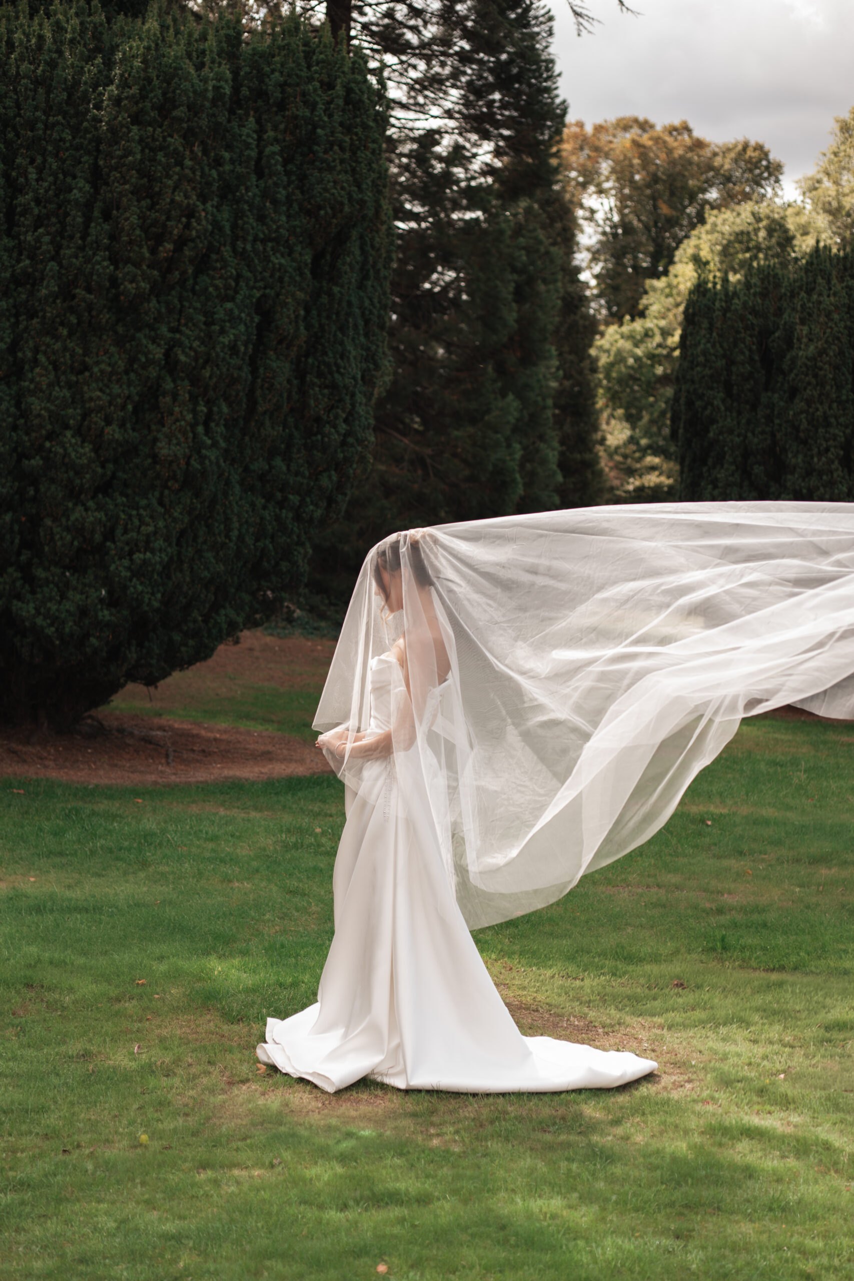 Bride with a long veil blowing in the wind